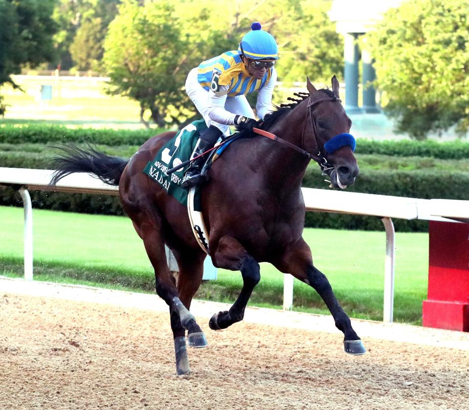 Joel Rosario, top, and Nadal cross the wire to win the second division of the Arkansas Derby on May 2.