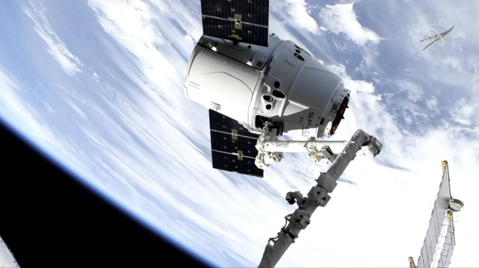 In this image taken from NASA Television, a SpaceX shipment arrives at the International Space Station following a weekend launch, Monday, May 6, 2019. The Dragon capsule reached the orbiting complex Monday, delivering 5,500 pounds (2,500 kilograms) of equipment and experiments. (NASA TV via AP)