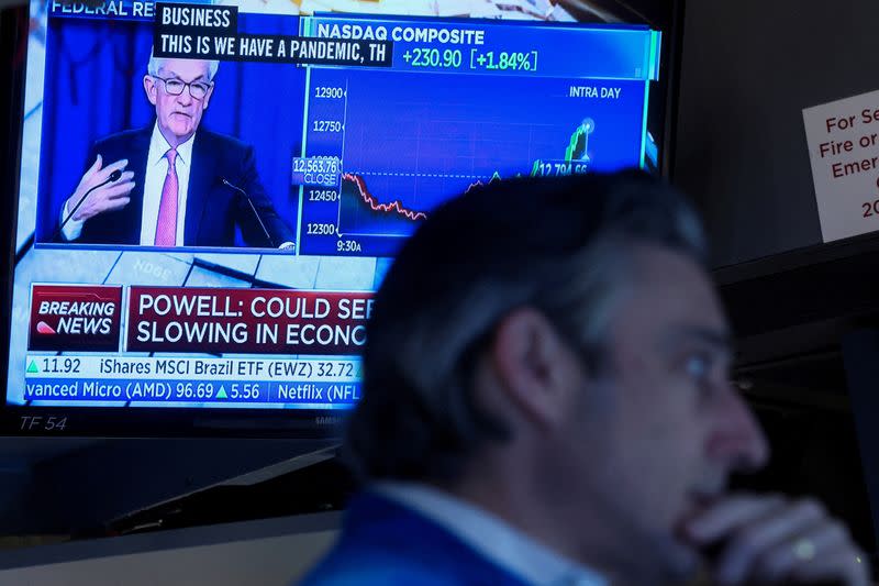 FILE PHOTO: Traders work on the floor of the NYSE in New York