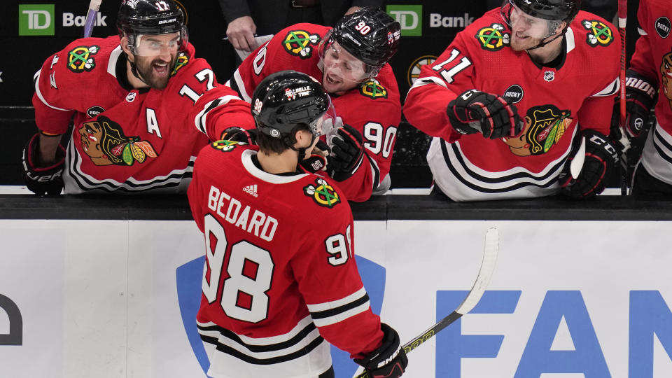 Connor Bedard's Blackhawks teammates went wild after the rookie's big milestone on Wednesday night. (AP Photo/Charles Krupa)