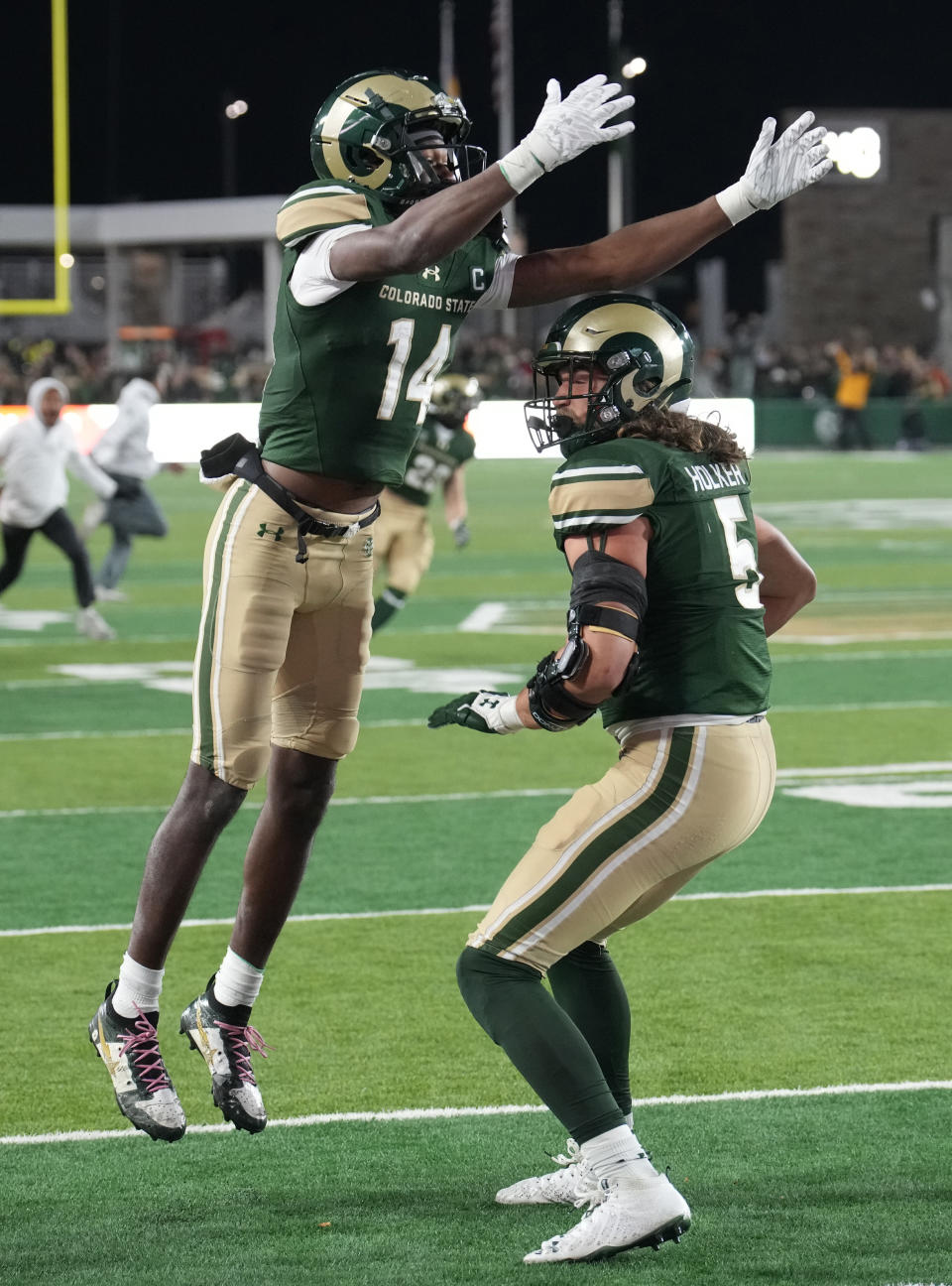 Colorado State wide receiver Tory Horton, left, congrastulates tight end Dallin Holker after he caught a pass for a touchdown to tie the score in the second half of an NCAA college football game against Boise State on Saturday, Oct. 14, 2023, in Fort Collins, Colo. (AP Photo/David Zalubowski)