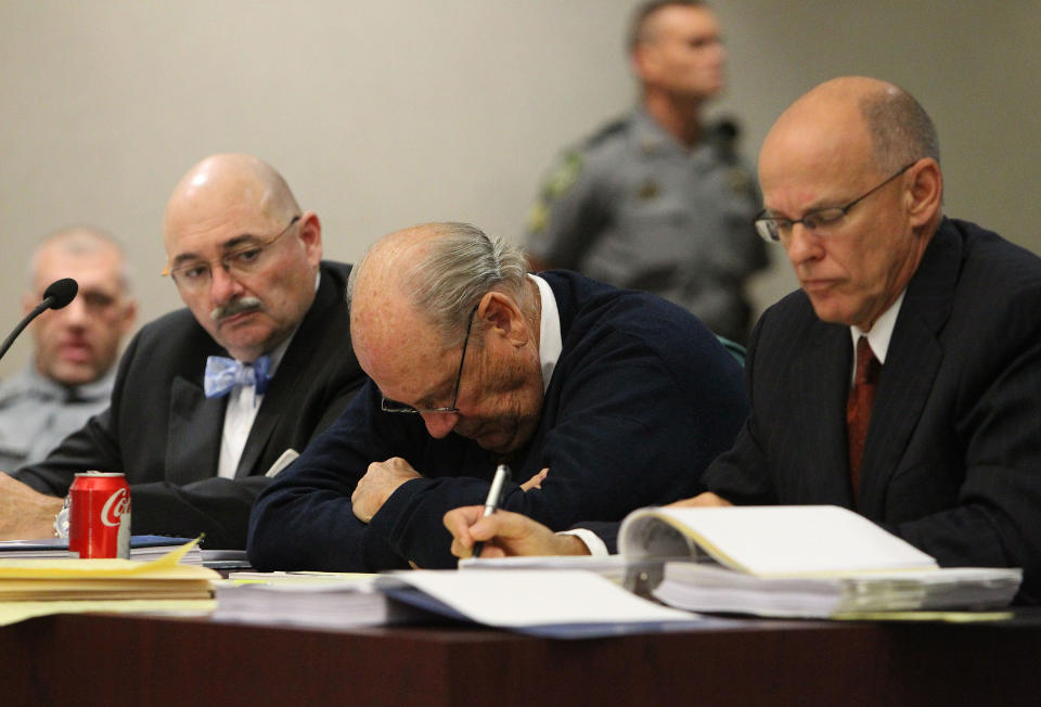 Former Tampa Police captain Curtis Reeves, Jr., center, sits beside his defense attorneys Richard Escobar, right, and Dino Michaels as they listen to his taped interview by detectives during his bond reduction hearing before Circuit Judge Pat Siracusa at the Robert D. Sumner Judicial Center in Dade City Friday, Feb. 7, 2014. Reeves is suspected of fatally shooting Chad Oulson, 43, and wounding his wife, Nicole, 33, during an argument Jan. 13 over texting at the Cobb Grove 16 theater in Wesley Chapel, Fla. (AP Photo/Pool Tampa Bay Times, Brendan Fitterer, Pool)