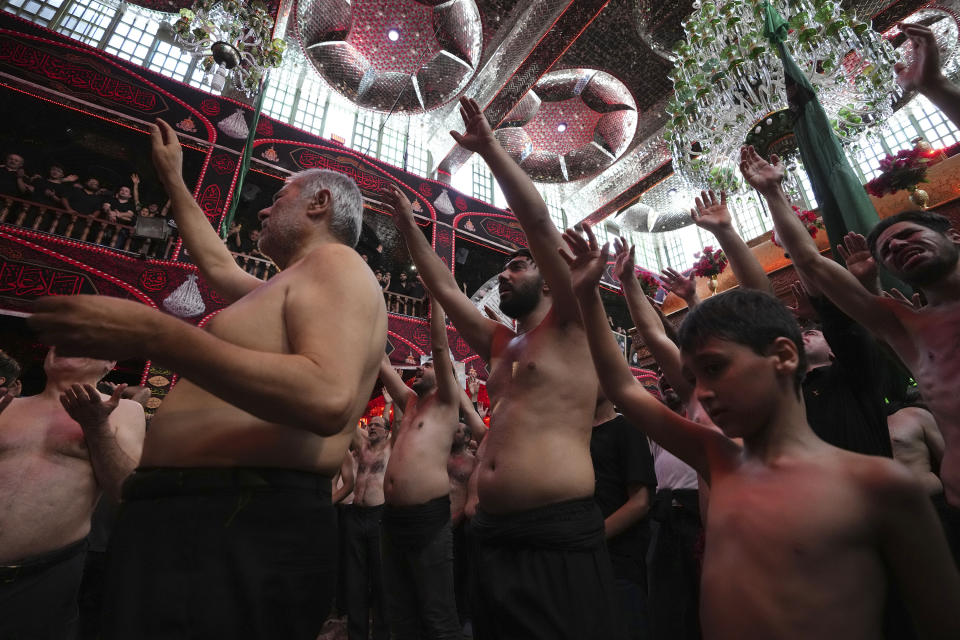 Iranian and Iraqi Shiite Muslims beat their heads and chests during the Ashoura mourning ritual in downtown Tehran, Iran, Friday, July 28, 2023. Millions of Shiite Muslims in Iran, Afghanistan, Pakistan and around the world on Friday commemorated Ashoura, a remembrance of the 7th-century martyrdom of the Prophet Muhammad's grandson, Hussein, that gave birth to their faith. (AP Photo/Vahid Salemi)