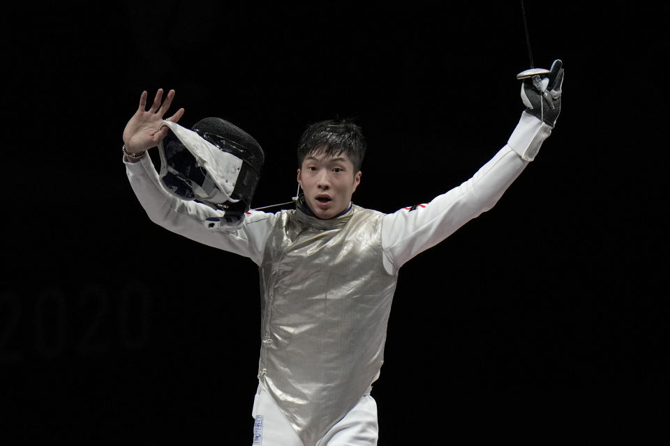 Ka Long Cheung of Hong Kong celebrates defeating Daniele Garozzo of Italy in the men's individual final Foil competition at the 2020 Summer Olympics, Monday, July 26, 2021, in Chiba, Japan. (AP Photo/Hassan Ammar)