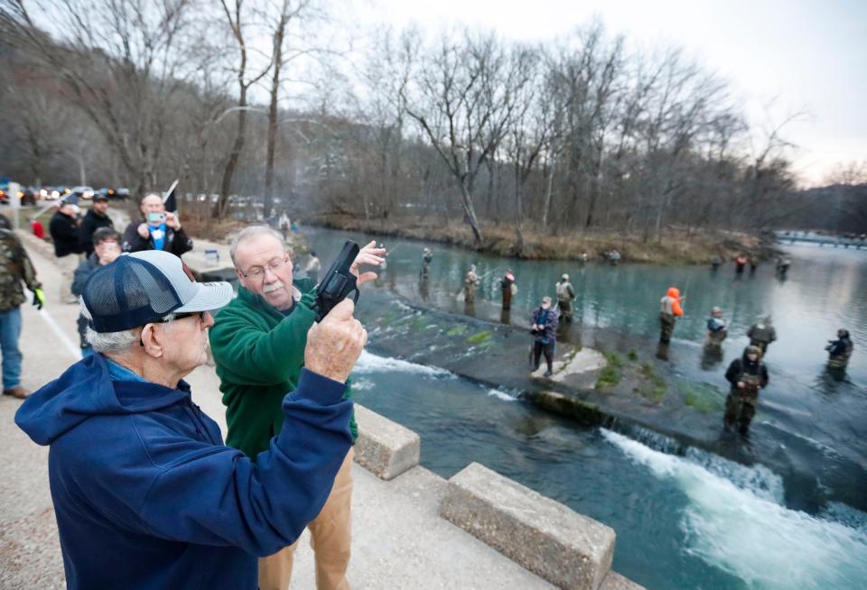 Oran Naramore, 89, fires a starter pistol, kicking off the beginning of catch-and-keep trout season in Missouri at Montauk State Park on Wednesday, March 1, 2023.