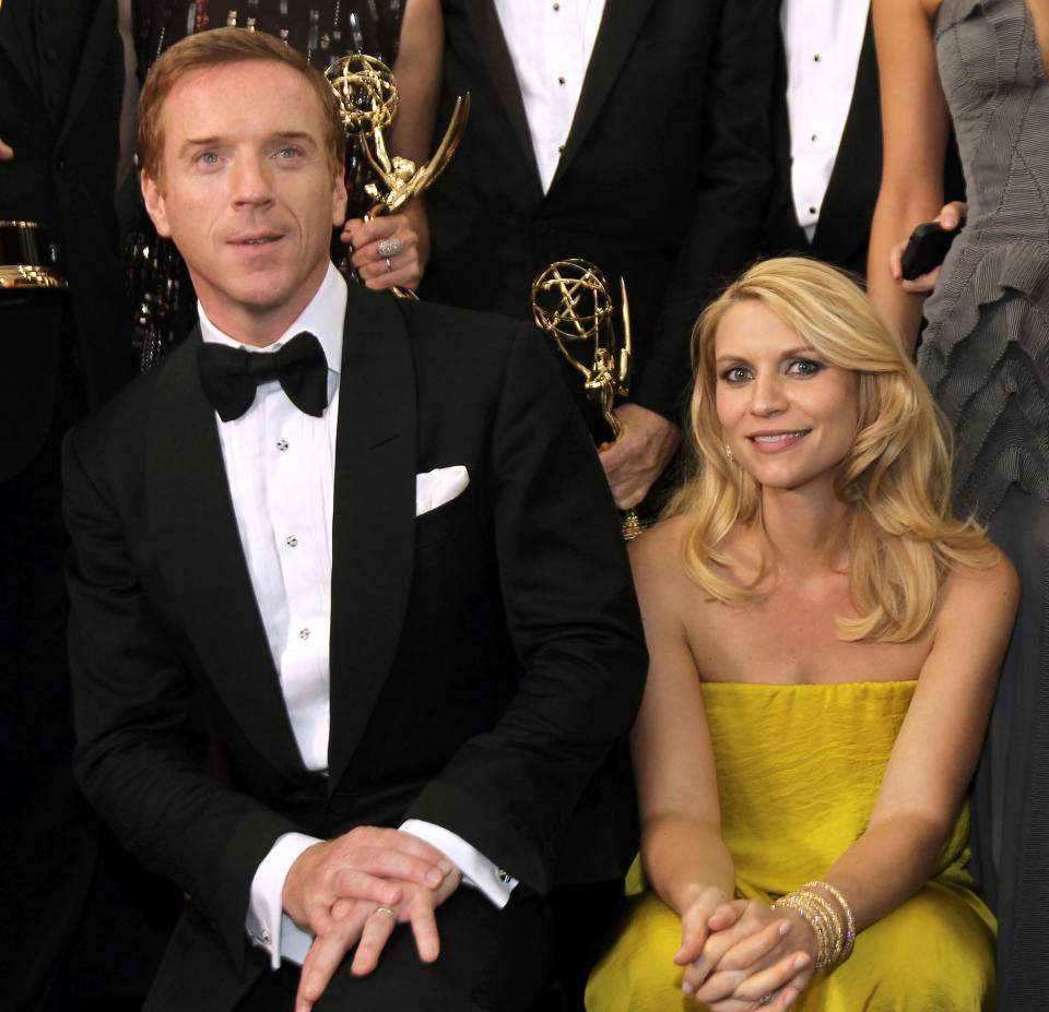 Actor Damien Lewis, left, winner of the Emmy for outstanding lead actor in a drama series for "Homeland" and actress Claire Danes, winner of the Emmy for outstanding lead actress in a drama series, also for "Homeland", pose backstage at the 64th Primetime Emmy Awards at the Nokia Theatre on Sunday, Sept. 23, 2012, in Los Angeles. (Photo by Matt Sayles/Invision/AP)