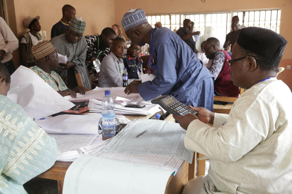 Electoral officials compile voting results at a collation center in Yola, n Nigeria, Sunday, Feb. 24, 2019. Vote counting continued Sunday as Nigerians awaited the outcome of a presidential poll seen as a tight race between the president and a former vice president. (AP Photo/Sunday Alamba)