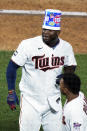 Minnesota Twins' Miguel Sano wears the bubble gum container on his head following his walk-off, two-run home run against the Cincinnati Reds in the 12th inning of a baseball game, early Tuesday, June 22, 2021, in Minneapolis. The Twins won 7-5. (AP Photo/Jim Mone)