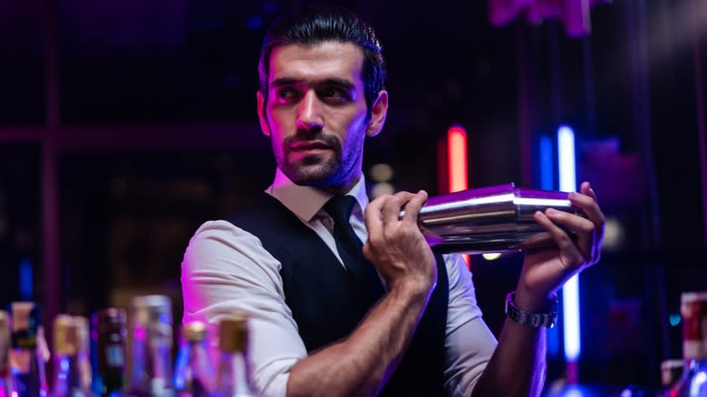 Bartender using drink shaker