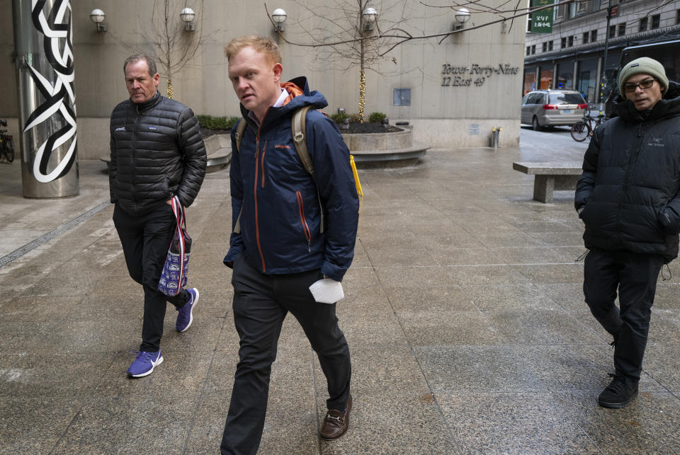 Morgan Sword, Major League Baseball Executive Vice President of Operations, center, arrives for a meeting in New York, Monday, Jan. 24, 2022, for the first in-person baseball negotiating session since the MLBlockout began. At left is Colorado Rockies owner Dick Montfort. (AP Photo/Craig Ruttle)