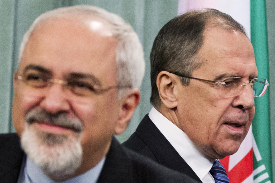 Russian Foreign Minister Sergey Lavrov, right, and his Iranian counterpart Javad Zarif, right, attend a news conference at the Foreign Ministry in Moscow, Russia, Thursday, Jan. 16, 2014. Russia said Iran will “inevitably” take part in any resolution of the civil war in Syria, and that Moscow is not working on a separate track with Damascus and Tehran to resolve the conflict. (AP Photo/Pavel Golovkin)