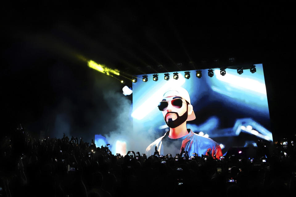 FILE - An avatar of El Salvador's President Nayib Bukele is projected on a giant screen during the closing ceremony of a congress for cryptocurrency investors, in Santa Maria Mizata, El Salvador, Nov. 20, 2021. The Salvadoran leader has sparked a sort of populist fervor in his Central American nation and is gaining traction from Colombia to Guatemala and the Dominican Republic as politicians seek to mimic "Bukeleism". (AP Photo/Salvador Melendez, File)