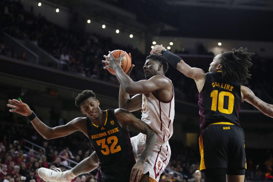 Southern California forward Kijani Wright, center, grabs a rebound between Arizona State forward Alonzo Gaffney (32) and guard Frankie Collins (10) during the second half of an NCAA college basketball game Saturday, March 4, 2023, in Los Angeles. (AP Photo/Marcio Jose Sanchez)