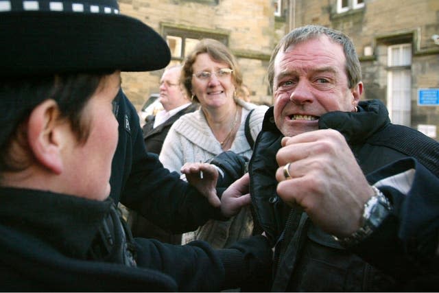 Michael Hamilton restrained by police