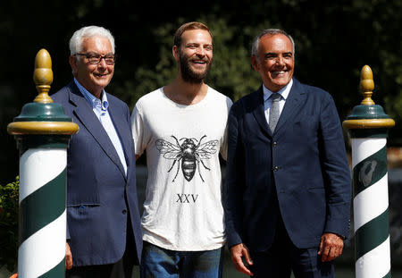 Italian actor Alessandro Borghi (C) poses with Venice Film Festival Director Alberto Barbera (R) and La Biennale di Venezia president Paolo Baratta a day before the opening of the 74th Venice Film Festival in Venice, Italy August 29, 2017. REUTERS/Alessandro Bianchi