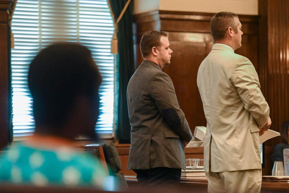 Ex-officer Chris Hickman, center, stands with his attorney, Thomas Amburgey, during his plea hearing August 9, 2019. Johnnie Rush,