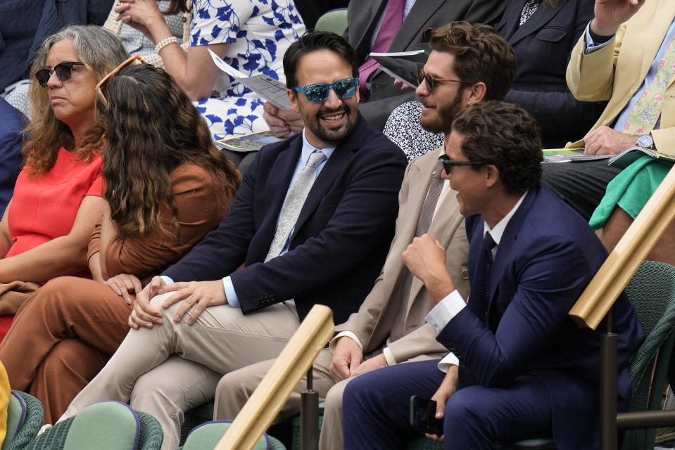 Actor Andrew Garfield, second right, and Lin-Manuel Miranda, center, sit in the Royal Box ahead of the final of the women's singles between the Czech Republic's Marketa Vondrousova and Tunisia's Ons Jabeur on day thirteen of the Wimbledon tennis championships in London, Saturday, July 15, 2023. (AP Photo/Kirsty Wigglesworth)
