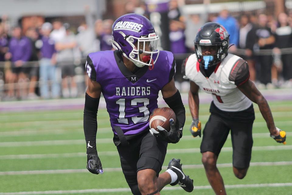 Mount Union defender Josh Jones returns an interception for a touchdown against Muskingum, Saturday, Sept. 23, 2023, at Kehres Stadium.