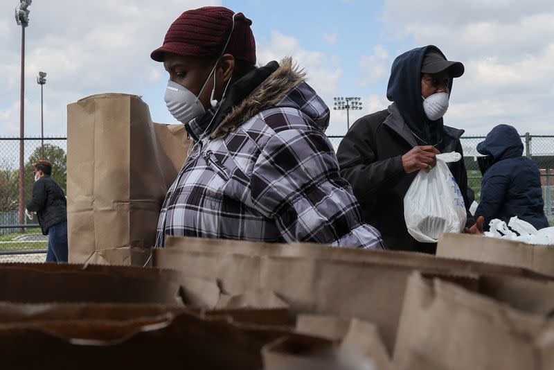 Volunteers distribute food to people in need during the coronavirus disease (COVID-19) outbreak from the Maya Angelou charter school in Washington