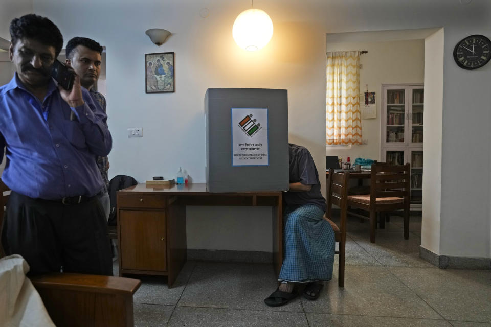 An elderly person casts his vote sitting in his home, in New Delhi, India, Friday, May 17, 2024. To encourage and assist elderly persons to cast their votes, the Election Commission of India initiated the home voting facility for the ongoing general parliamentary elections. (AP Photo/Manish Swarup)