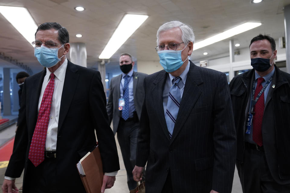 Sen. John Barrasso, R-Wyo., left, walks with Senate Minority Leader Mitch McConnell of Ky., on Capitol Hill in Washington, Friday, Feb. 12, 2021, on the fourth day of the second impeachment trial of former President Donald Trump. (AP Photo/Susan Walsh)