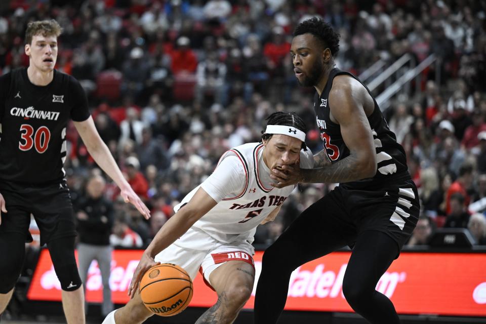 Texas Tech guard Darrion Williams draws a foul against Cincinnati forward Jamille Reynolds, right, during the first half of an NCAA college basketball game, Saturday, Feb. 3, 2024, in Lubbock, Texas. (AP Photo/Justin Rex)