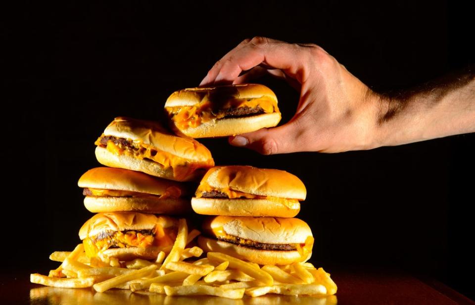 A pile of cheeseburgers and chips (Dominic Lipinski/PA) (PA Archive)
