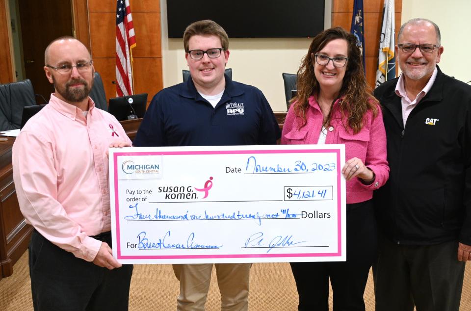 CBPU director Paul Jakubczak, Sam Frye from Hillsdale, Christy Ramey, Marshall assistant electric director, and Kevin Maynard, Marshall Utility director, with the check presented to Susan G. Komen - Michigan Foundation. The funds were raised by Michigan South Central Power Agency members, including Clinton.