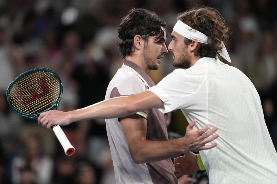 Taylor Fritz, left, of the U.S. is congratulated by Stefanos Tsitsipas of Greece following their fourth round match at the Australian Open tennis championships at Melbourne Park, Melbourne, Australia, Sunday, Jan. 21, 2024. (AP Photo/Alessandra Tarantino)