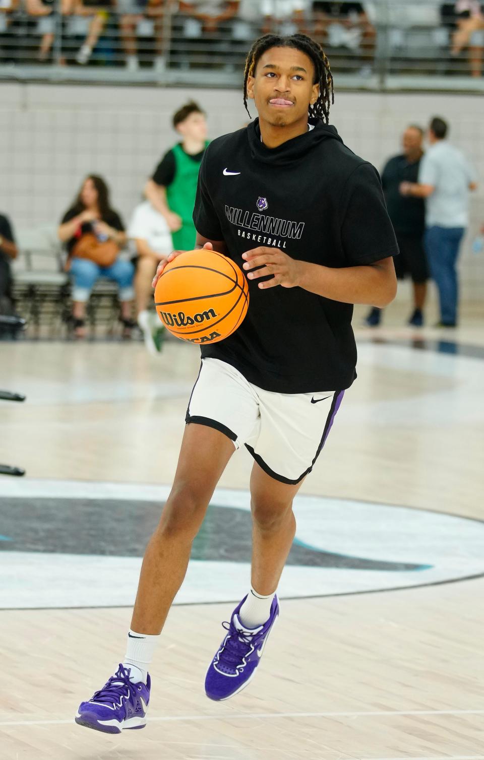 Millennium forward Cameron Holmes warms up with his team during the Section 7 Basketball Tournament at State Farm Stadium in Glendale on June 23, 2023.