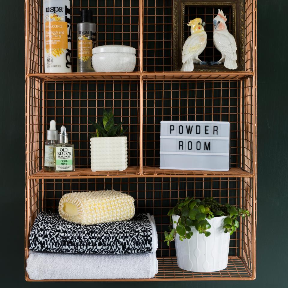 An upcycled wire bathroom shelf