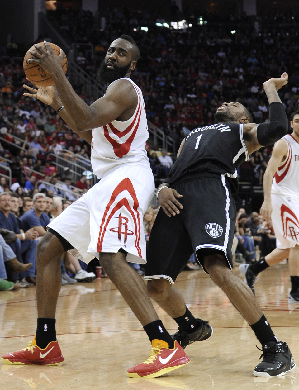 FILE - This Jan. 26, 2013 file photo shows Brooklyn Nets' C.J. Watson (1) backing away from Houston Rockets' James Harden (13) in the second half of an NBA basketball game in Houston. The Rockets won 119-106. In his first season with the Rockets after an October trade from Oklahoma City, Harden has already grown fond of the nation's fourth-largest city. He sat down with The Associated Press to give those planning a trip for the event tips on where to stay, what to eat and things to do. (AP Photo/Pat Sullivan, file)