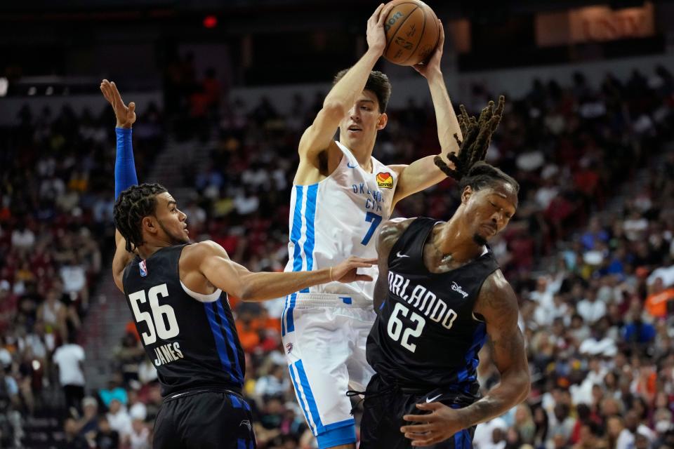 Oklahoma City's Chet Holmgren, center, looks for an open teammate during Monday night's Summer League game against Orlando.