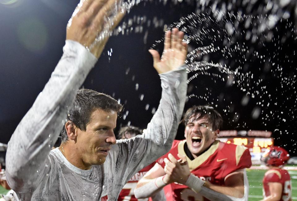 Cardinal Mooney head coach Jared Clark is doused with Gatorade and water after his team defeated North Florida Christian 41-14 in the Class 1 Suburban state semifinal on Friday at John Heath Field at Austin Smithers Stadium in Sarasota.