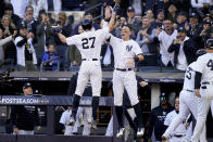 New York Yankees Giancarlo Stanton (27) celebrates with Aaron Judge after hitting a three-run home run against the Cleveland Guardians during the first inning of Game 5 of an American League Division baseball series, Tuesday, Oct. 18, 2022, in New York. (AP Photo/John Minchillo)