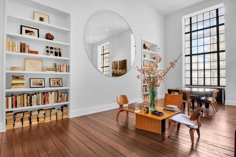 Design details include vintage restored wide-plank hardwood floors and circular infinity mirrors. Tina Gallo for Douglas Elliman