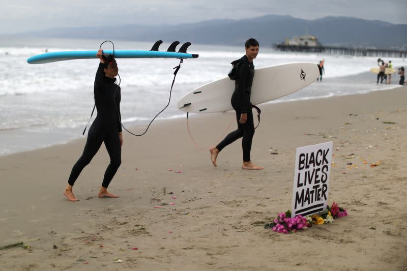 People step out of the ocean at The Black Girls Surf paddle-out in memory of George Floyd, who died in Minneapolis police custody, in Santa Monica