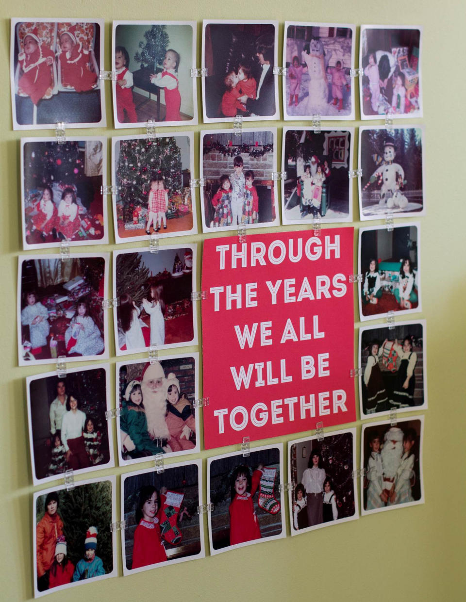 This photo taken on Dec. 2, 2013 shows a display that features family holiday photos and a snippet of the song “Have Yourself a Merry Little Christmas.” Small plastic clips make it easy to arrange and display a large number of photos without frames. The holidays are a great time to pull out the old photos and reminisce, but there's no need to huddle around a dusty album. (AP Photo/Holly Ramer)