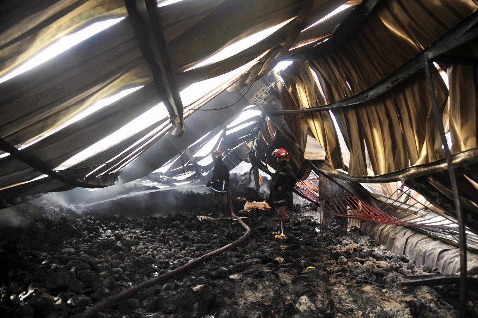 A Bangladeshi firefighter douses a fire at a garment factory in Gazipur outside Dhaka, Bangladesh, Wednesday, Oct. 9, 2013. The fire killed nearly a dozen people at the garment factory in Bangladesh about six months after a factory building collapse that killed 1,100 people exposed the harsh and often unsafe conditions in an industry that is the world's third-largest.  (AP)