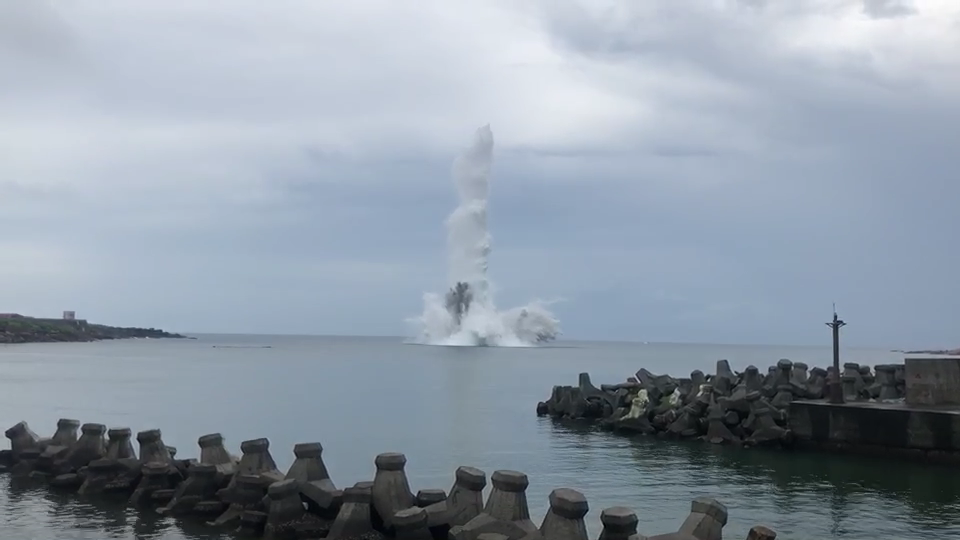 新北市貢寮區卯澳灣海中21日發現13顆未爆彈，軍方30日上午完成前置作業後，上午10時15分在岸上以遙控器引爆，現場海域濺起巨大高聳水花。（讀者提供）