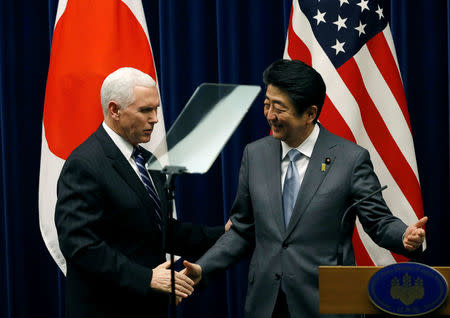 U.S. Vice President Mike Pence (L) and Japan's Prime Minister Shinzo Abe shake hands during their joint announcement after their meeting at Abe's official residence in Tokyo, Japan, February 7, 2018. REUTERS/Toru Hanai