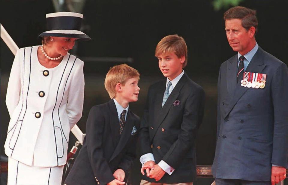 Princess Diana, her sons Harry and William, and Prince Charles watch the parade march past as part of the commemorations of VJ Day (AFP/Getty Images)