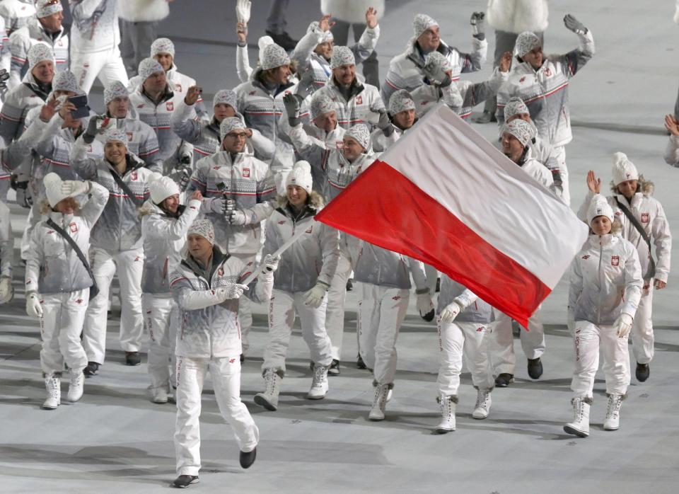 Poland's flag-bearer Dawid Kupczyk leads his country's contingent during the opening ceremony of the 2014 Sochi Winter Olympics, February 7, 2014. REUTERS/Mark Blinch (RUSSIA - Tags: OLYMPICS SPORT)