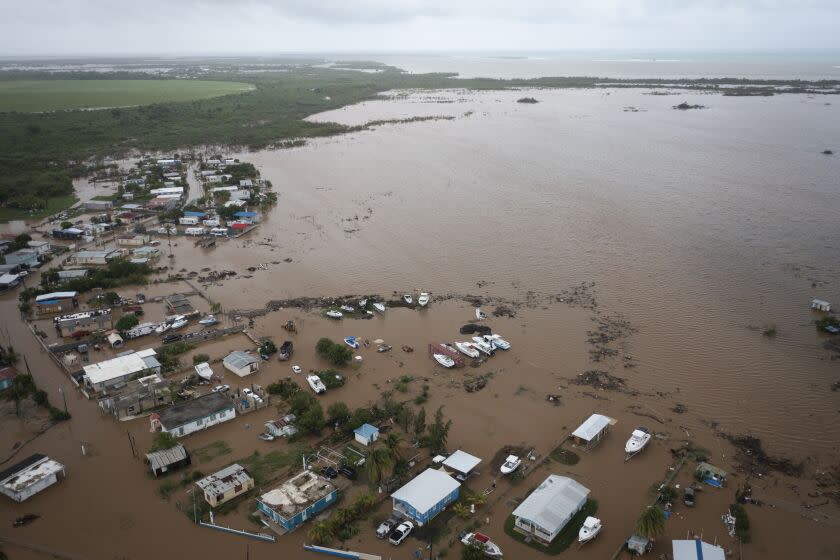 Homes are flooded on Salinas Beach after the passing of Hurricane Fiona in Salinas, Puerto Rico, Monday, Sept. 19, 2022. (AP Photo/Alejandro Granadillo)