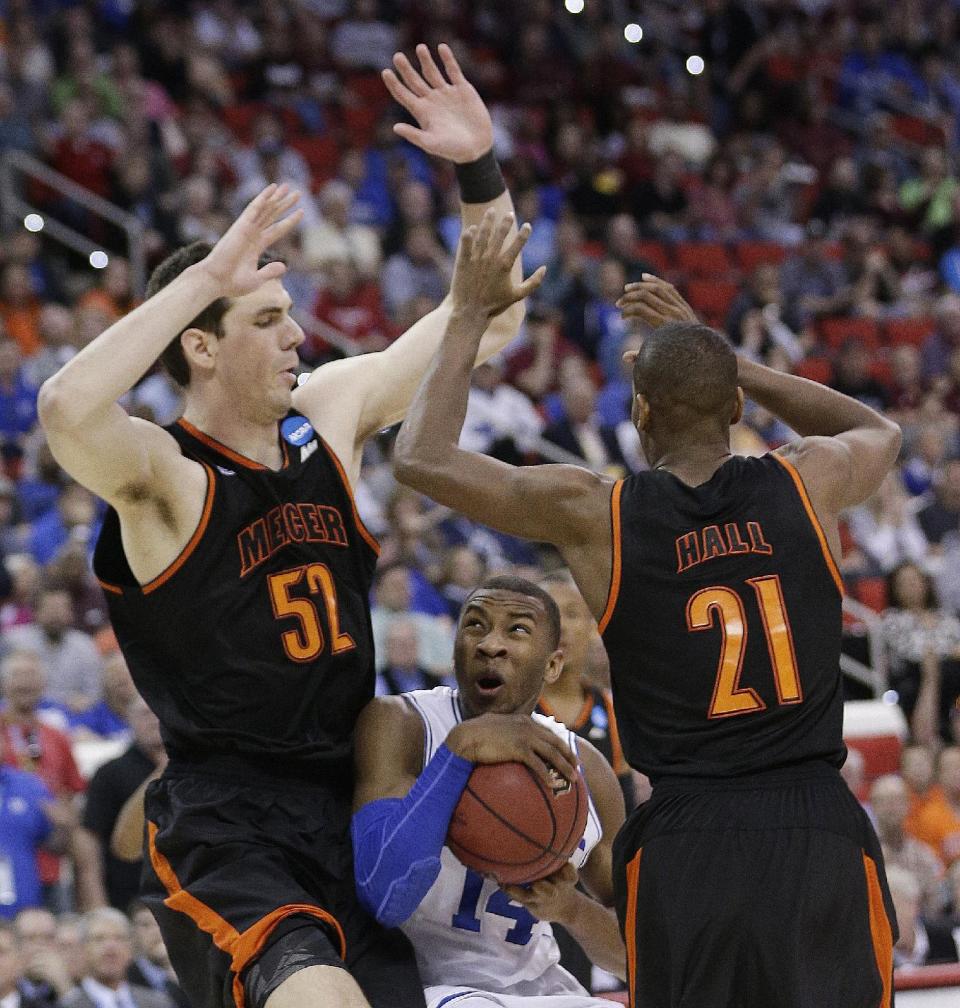 Duke guard Rasheed Sulaimon (14) works between Mercer's Daniel Coursey (52) and Langston Hall (21)during the second half of an NCAA college basketball second-round game, Friday, March 21, 2014, in Raleigh, N.C. (AP Photo/Chuck Burton)