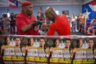 In this April 10, 2014 photo, IBF light heavyweight boxing champion Bernard Hopkins, right, works with trainer Naazim Richardson during a media workout in Philadelphia. Hopkins will attempt to become the oldest fighter in boxing history to unify world titles when he opposes WBA champion Beibut Shumenov April 19th at the DC Armory. (AP Photo/Matt Rourke)