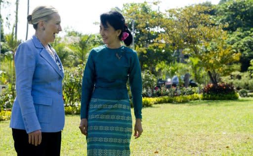 Pro-democracy opposition leader Aung San Suu Kyi and US Secretary of State Hillary Clinton tour the grounds of Suu Kyi's residence in Yangon on December 2, 2011