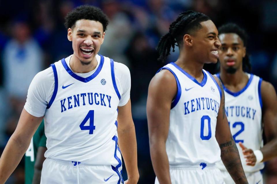 Kentucky forward Tre Mitchell (4) smiles with guard Rob Dillingham (0) after a play against Miami during Tuesday’s ACC/SEC Challenge game at Rupp Arena.