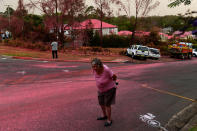 SYDNEY, AUSTRALIA - NOVEMBER 12: A resident walks infront of South Turramurra homes which were bombed by fire-retardant during NSW RFS firefighting efforts on November 12, 2019 in Sydney, Australia. More than 60 fires are burning across NSW with 200 homes and sheds destroyed and three people confirmed dead. Catastrophic fire danger - the highest possible level of bushfire danger - has been forecast for the greater Sydney, Illawarra and Hunter areas which includes the Blue Mountains and the Central Coast. NSW Premier Gladys Berejiklian declared a state of emergency on Monday, giving giving emergency powers to Rural Fire Service Commissioner Shane Fitzsimmons and prohibiting fires across the state. (Photo by Sam Mooy/Getty Images)