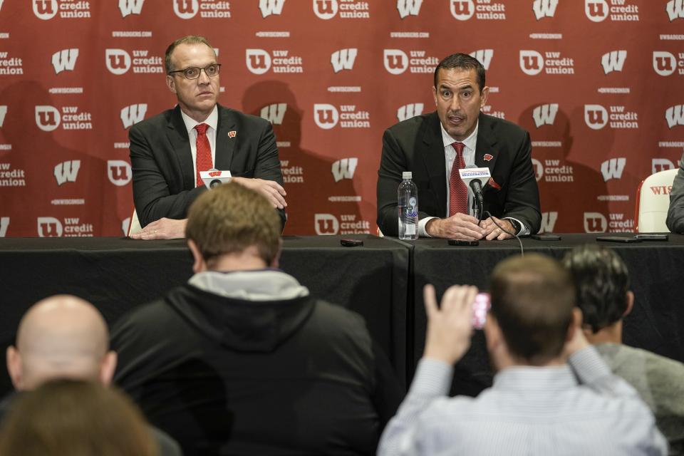 FILE - Wisconsin athletic director Chris McIntosh, left, introduces new head football coach Luke Fickell at a news conference Monday, Nov. 28, 2022, in Madison, Wis. McIntosh’s emergence as Wisconsin’s athletic director after playing football for the Badgers and working as predecessor Barry Alvarez’s right-hand man seemed to indicate things would stay essentially the same at a school that prides itself on stability. It hasn’t worked out that way. (AP Photo/Morry Gash, File)